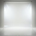 A plain photography backdrop in a studio setting, featuring a seamless white surface. Royalty Free Stock Photo