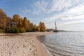 Plain river with sandy shore with trees, moored floating crane Royalty Free Stock Photo