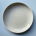 A plain round ceramic plate with a smooth, glossy surface and subtle concentric Royalty Free Stock Photo