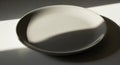 A plain, round white plate is Royalty Free Stock Photo