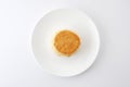 Plain scone biscuit isolated on a plate on white background