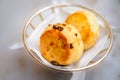 Plain scone and raisin scone in basket with white linen