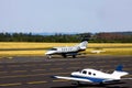 plain sports airplane and a business jet on a small airport