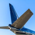 Plain tail over blue sky background. Details of the cargo and c