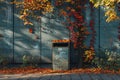 A plain trash can is positioned in front of a vibrant green wall, creating a simple urban scene, mockup Royalty Free Stock Photo