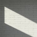Plain white brick wall with a diagonal shadow cast across its surface. The bricks are Royalty Free Stock Photo
