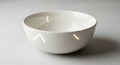 A plain white ceramic bowl with a glossy finish is placed on a smooth, light-colored Royalty Free Stock Photo