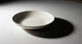 A plain white ceramic bowl sits Royalty Free Stock Photo