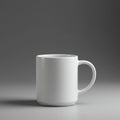 A plain white ceramic mug is centered on a smooth, gray surface, complemented by a Royalty Free Stock Photo
