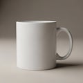 A plain white ceramic mug is centrally positioned on a neutral, light gray surface. It has a Royalty Free Stock Photo