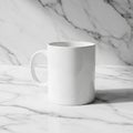 A plain white ceramic mug is placed on a marble surface with a matching marble Royalty Free Stock Photo