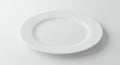 A plain, white, ceramic oval plate is positioned on a white surface. The lighting creates Royalty Free Stock Photo