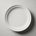 Plain white ceramic plate centered against a textured, light gray background. Royalty Free Stock Photo
