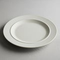 A plain, white ceramic plate rests Royalty Free Stock Photo