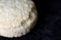 Plain white cookie on black board macro