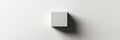 White cube casting a shadow on a light gray background in a minimalistic interior design setting. Generative AI Royalty Free Stock Photo
