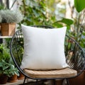 A plain white cushion sits on a chair in a garden setting ready for customization Royalty Free Stock Photo