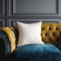 A plain white cushion sits on a luxurious vintage sofa with a dark grey wall in the background Royalty Free Stock Photo