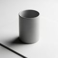 Plain white cylindrical mug on a white surface, casting a soft shadow Royalty Free Stock Photo