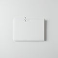 A plain, white folder resting on a textured light grey background. The folder is closed Royalty Free Stock Photo
