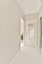 a plain white hallway with a door to a hallway Royalty Free Stock Photo