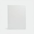 A plain white hardcover book with a smooth texture, displayed against a light grey Royalty Free Stock Photo