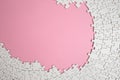 Plain white jigsaw puzzle frame on pink color, background, abstract backdrop Royalty Free Stock Photo