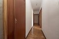 Plain white painted corridor with entrance to various rooms, fitted wardrobes Royalty Free Stock Photo
