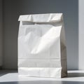 Plain White Paper Bag Standing Upright on Clean Surface with Soft Natural Light Minimal Packaging Mockup Design. Royalty Free Stock Photo