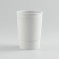 A plain white paper coffee cup with a protective sleeve is centered on a light gray Royalty Free Stock Photo