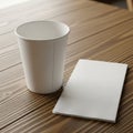 A plain white paper cup and a folded white napkin are placed on a wooden table with Royalty Free Stock Photo