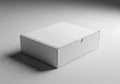 A plain white rectangular box with a lid casting a subtle shadow on a light gray surface Royalty Free Stock Photo