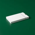 A plain white rectangular box made of paperboard lies on a dark green surface. The b Royalty Free Stock Photo