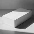 A plain, white rectangular box is placed on a smooth surface. The box is lit by a beam of light, Royalty Free Stock Photo