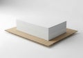 A plain white rectangular box sits on a brown cardboard base isolated on a clean white surface Royalty Free Stock Photo