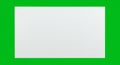A plain white rectangular sheet positioned against a vibrant green background. The Royalty Free Stock Photo
