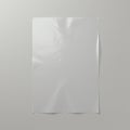 A plain white sheet of paper with subtle creases is centered on a gray background. It Royalty Free Stock Photo