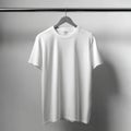 Plain white tee shirt hanging on a gray hanger against a light gray studio backdrop showing texture Royalty Free Stock Photo