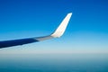 Plain wing over blue sky. Flight from Amsterdam to Helsinki Royalty Free Stock Photo