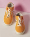 Plain yellow converse sneakers isolated on a bright background