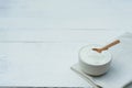 Plain yoghurt in white bowl and wood spoon on white wooden table background Royalty Free Stock Photo