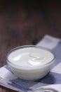 Plain yogurt in small glass bowl