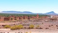 Plains of Morocco featuring mud brick houses and vast greenery and mountains in the background