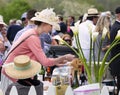 Women wearing hat at a tailgate party at horse race