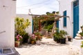 Plaka Town on Milos Island - picturesque narrow stone street with traditional greek whitewashed walls, blue doors, Greece.