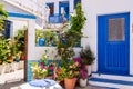 Plaka Town on Milos Island - picturesque narrow stone street with traditional greek whitewashed walls, blue doors, Greece