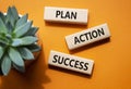 Plan Action Success symbol. Concept word Plan Action Success on wooden blocks. Beautiful orange background. Business and Plan Royalty Free Stock Photo