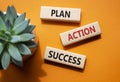 Plan Action Success symbol. Concept word Plan Action Success on wooden blocks. Beautiful orange background. Business and Plan Royalty Free Stock Photo