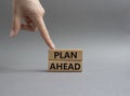 Plan ahead symbol. Wooden blocks with words Plan ahead. Beautiful grey background. Businessman hand. Business and Plan ahead Royalty Free Stock Photo