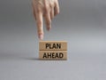 Plan ahead symbol. Wooden blocks with words Plan ahead. Beautiful grey background. Businessman hand. Business and Plan ahead Royalty Free Stock Photo